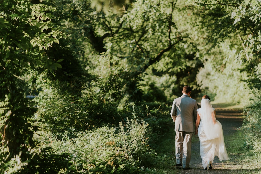 Bride and groom walking in woods